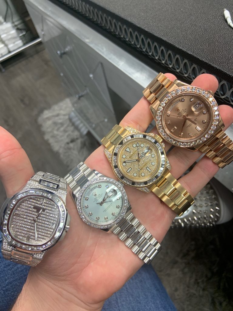 three iced out rolex watches held together from left to right: rolex day date, rolex datejust and rolex gmt master ii